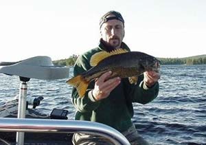 The author’s friend John with a nice late fall smallie.