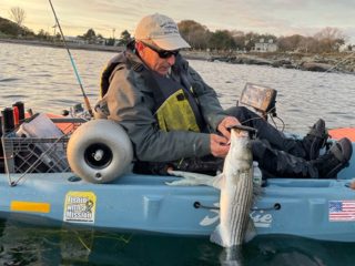 Marco Cicerano with kayak caught striped bass
